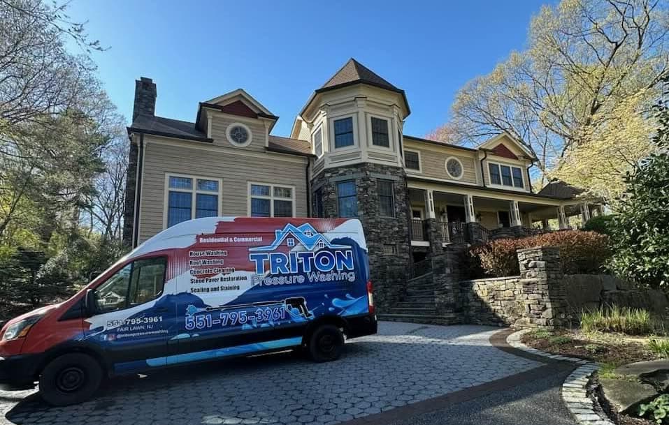 Triton Pressure Washing branded van in front of a clean Bergen County home